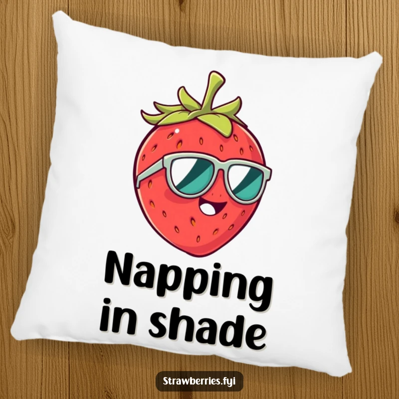 Funny pillow showcasing a giggling strawberry character in tiny sunglasses, offering plush comfort and humorous charm.