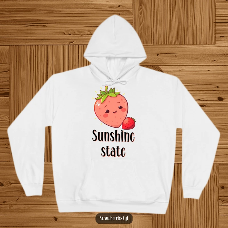 Funny sunny strawberry hoodie with a character basking in light, offering cozy warmth and humorous, bright cheerfulness.