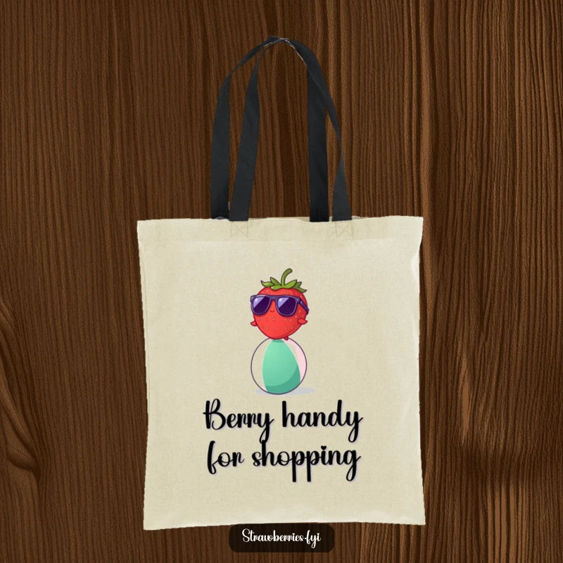 Funny strawberry wearing sunglasses balancing on a beach ball, a humorous tote bag for summer outings.